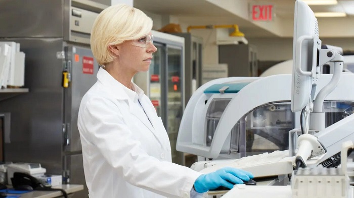 A scientist is working with lab equipment at the lab center, some chemical solutions can be seen there.